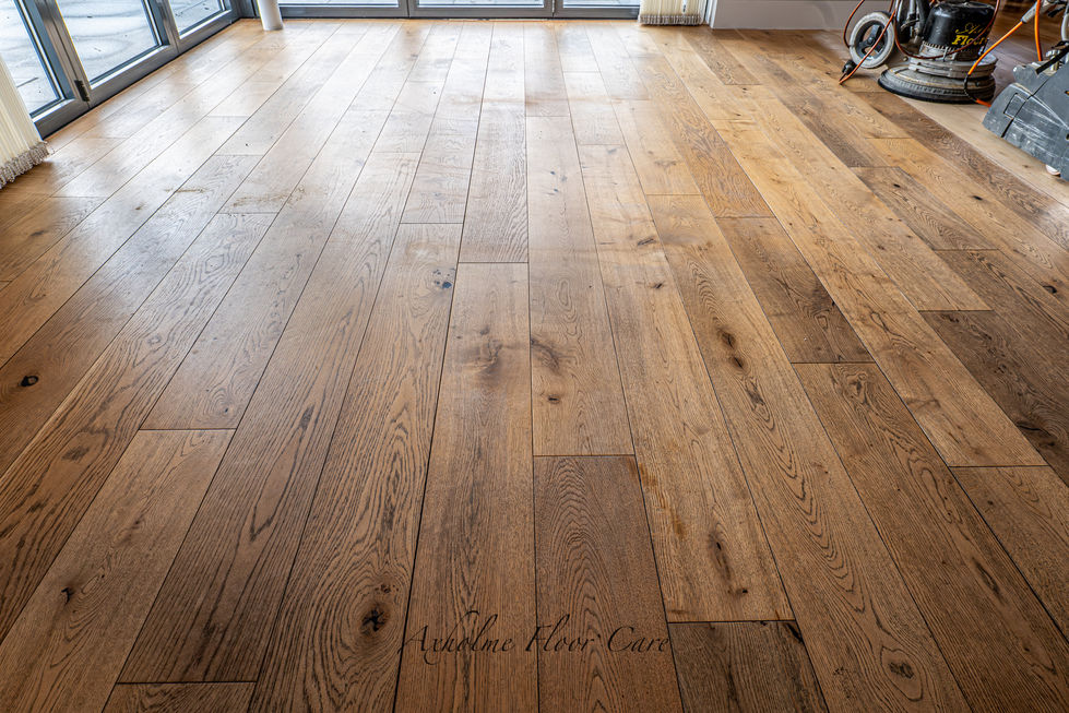 Before sanding of a worn engineered oak floor in a Scunthorpe home showing surface wear and old coating