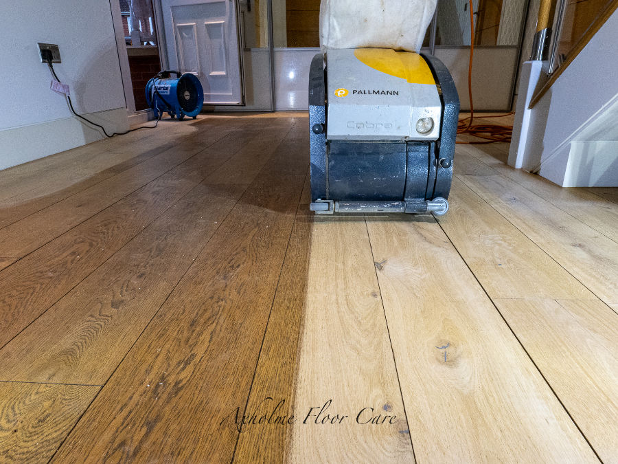 Close-up view of sanding machine smoothing a wooden floor