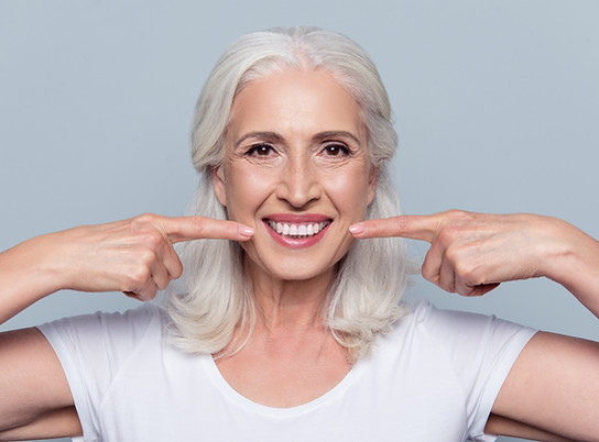 Concept of having strong healthy straight white teeth at old age. Close up portrait of hap