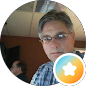 Man with glasses in a plaid shirt with a star icon overlay