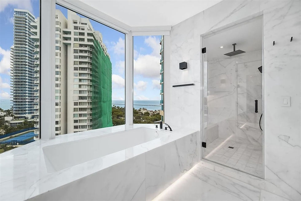 Wide angle view of a luxurious bathroom featuring a freestanding tub and elegant tile work