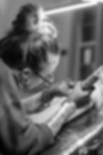 A photo of Em Nicole tattooing a client