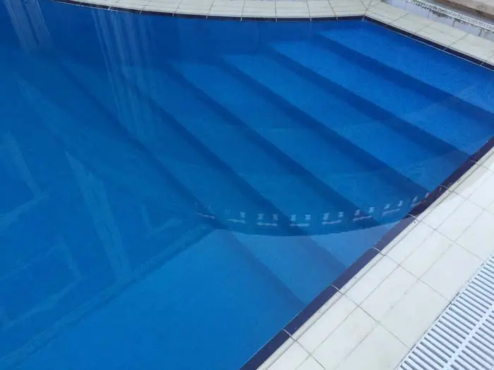 Reef Pebble Aqualux vinyl pool liner installed in modern swimming pool with entry steps NZ