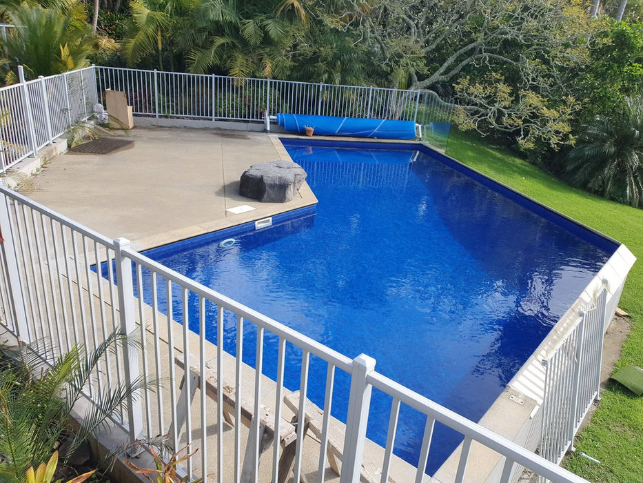 Aerial view of L-shaped vinyl liner pool with rock feature, Auckland