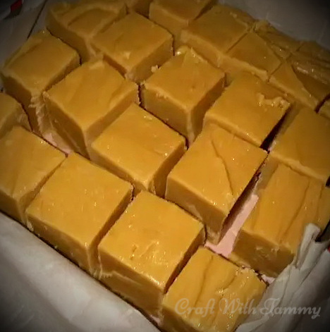 Homemade fudge on a parchment-lined tray, ready to slice