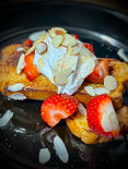 Keto French Toast topped with sugar free syrup, whipped cream and fresh berries