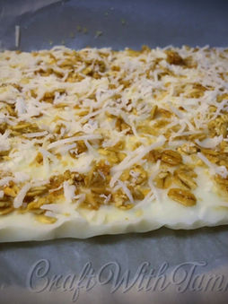 Frozen yogurt bark topped with coconut granola and drizzled honey