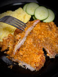 alt="Golden brown crunchy keto pork chops on a plate, crispy low-carb coating with herbs"