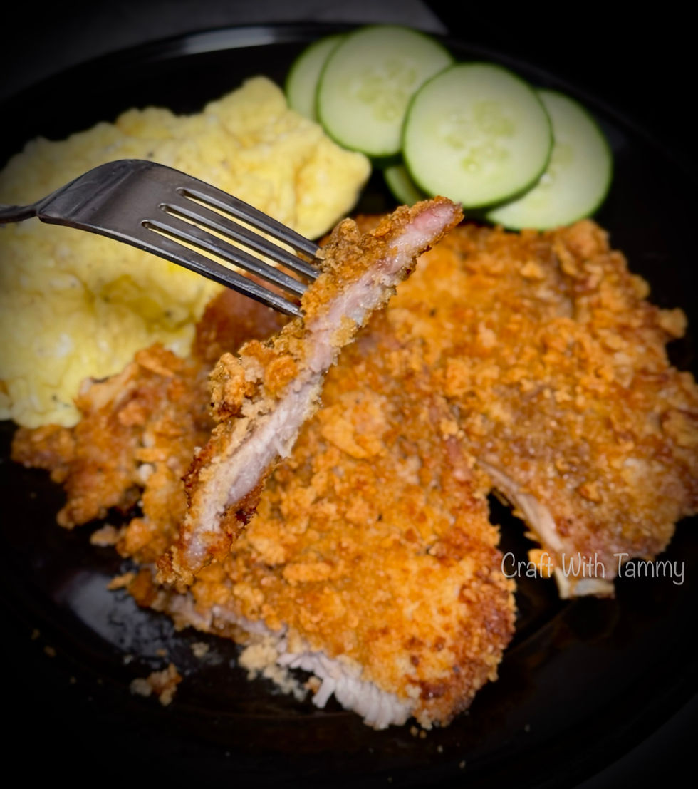 Golden brown crunchy keto pork chops on a plate, crispy low-carb coating with herbs