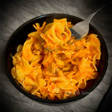 Golden, bubbly egg noodle casserole topped with melted cheese