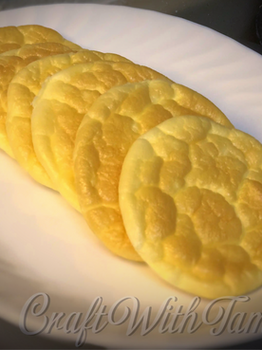Fluffy, golden keto-friendly cloud bread stacked on a plate, light and airy with a dreamy texture