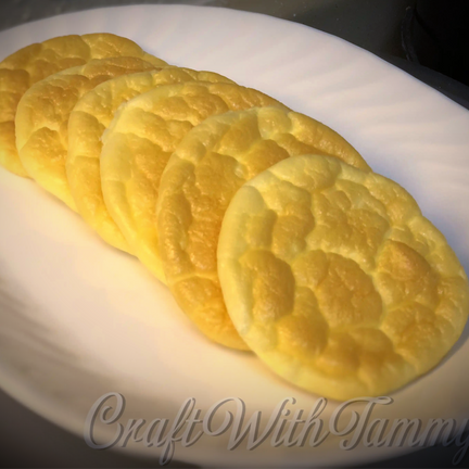 alt="Fluffy, golden keto-friendly cloud bread stacked on a plate, light and airy with a dreamy texture"