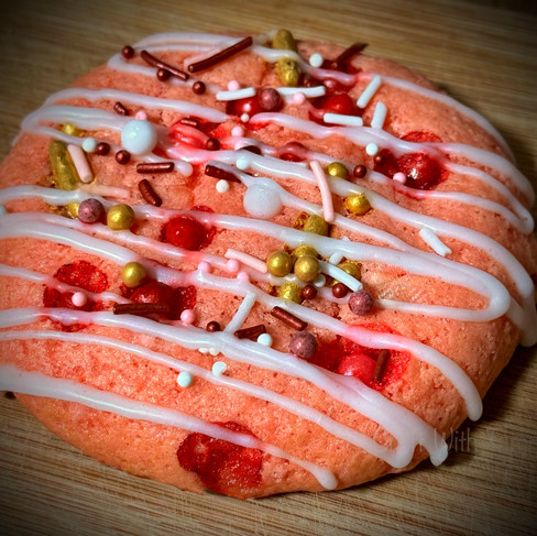 Pink cake mix cookies decorated with colorful sprinkles