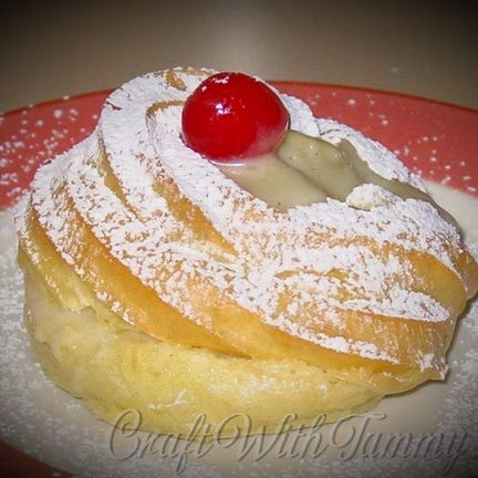 Traditional Italian Zeppole di San Giuseppe topped with custard and cherry