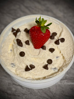 Bowl of keto cannoli dip topped with sugar-free chocolate chips, served with low-carb cookies.