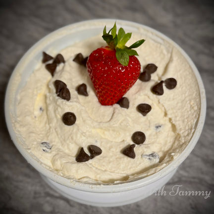 Bowl of keto cannoli dip topped with sugar-free chocolate chips, served with low-carb cookies.