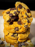 Stack of keto chocolate chip cookies on parchment paper display