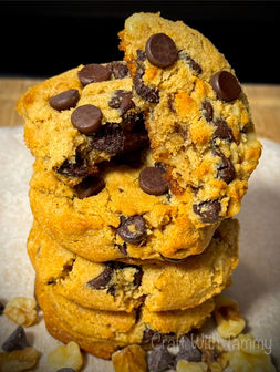 Stack of keto chocolate chip cookies on parchment paper display