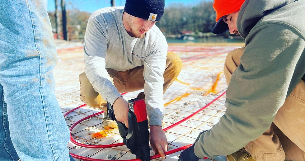 Scenic Air installers fasten hydronic pex tubing in place as they install radiant heat in a Chattanooga home