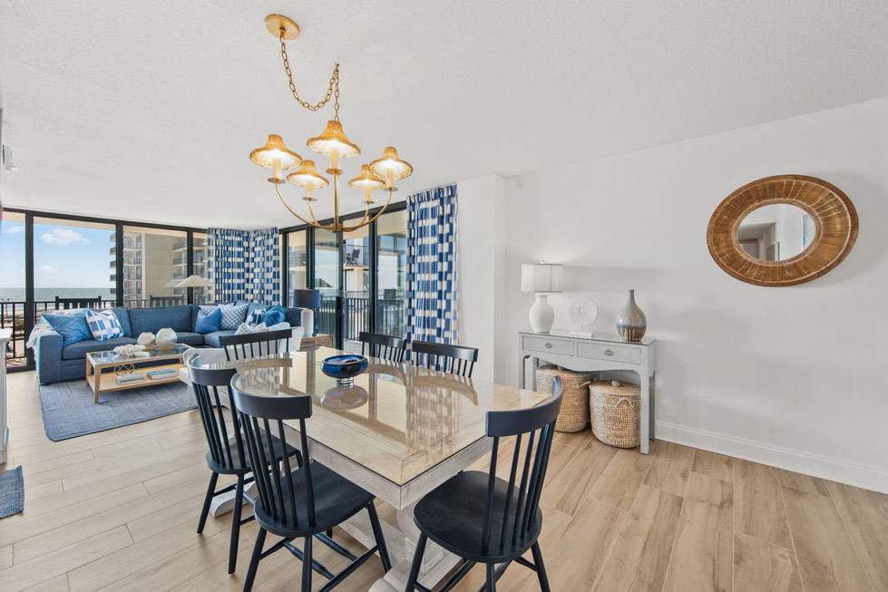 natural wood dining room with black chair and gold accents.