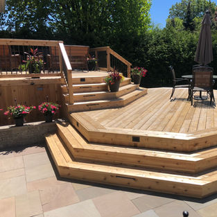Custom multi-level cedar wood deck with built-in stairs and outdoor seating area