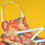 Thumbnail: An angled image of a printed apron, with orange and yellow leaf print