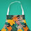 Thumbnail: An image of a printed apron, with teal and yellow leaf print