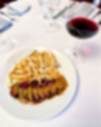 Eye-level view of a beautifully arranged cheese platter with wine