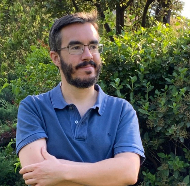 Portrait photo of the psychiatrist, neutral background, warm and professional, vertical/portrait orientation