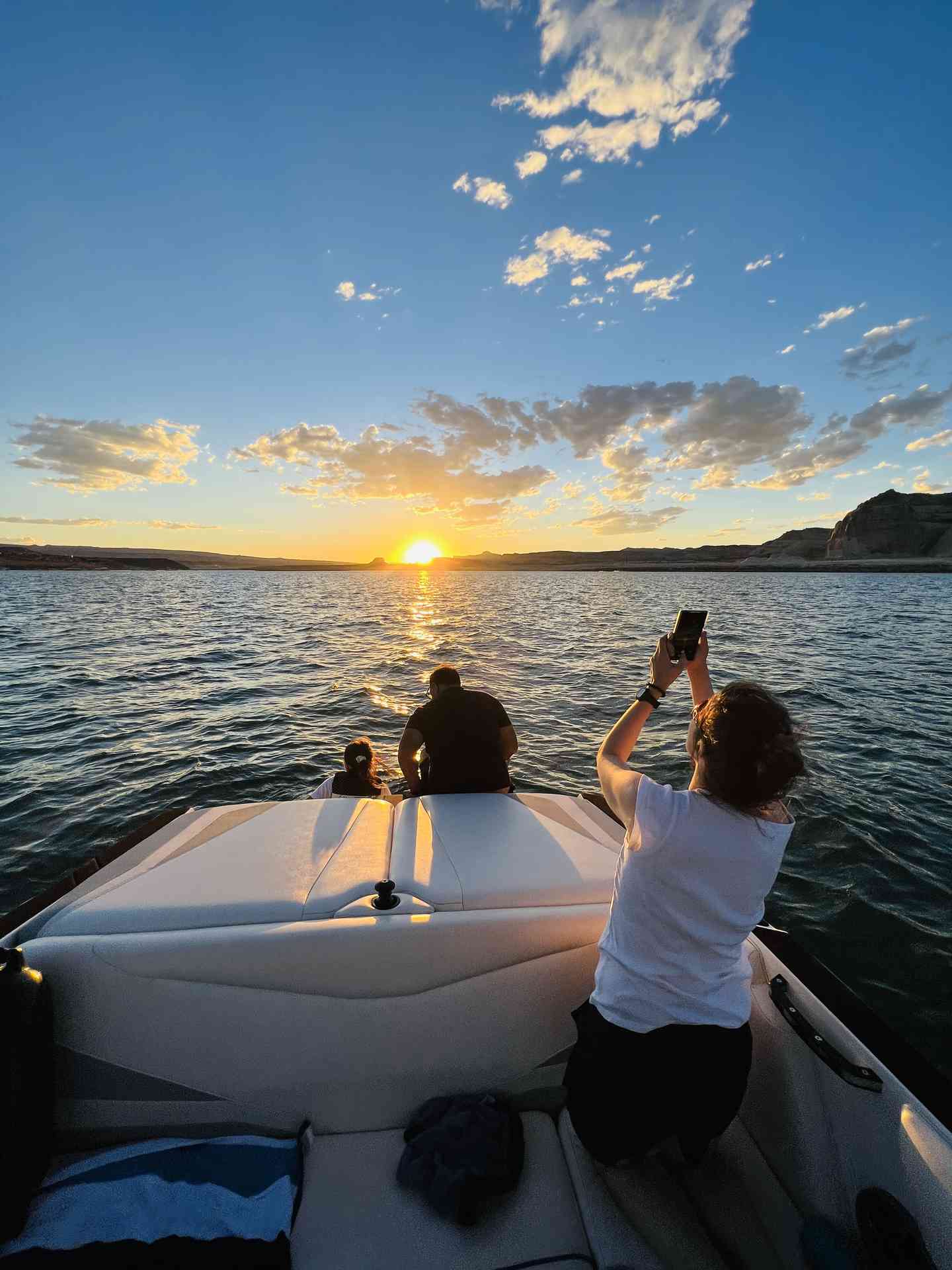 A person captures a sunset photo during a Lake Powell Experience boat tour.