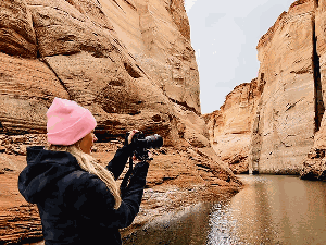 A woman captures the beauty of Antelope Canyon during a two‑hour Lake Powell Experience ph