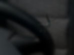 close up of a stone chip in the windshield of a car, detail shot of cracks in car glass on