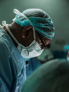 Close up of a doctor wearing surgical mask in an operating room.