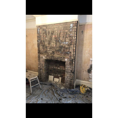 Exposed brickwork around a fireplace