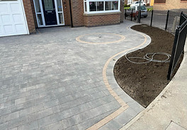 Driveway with one curved edge, at the front of a house