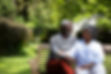 front-view-senior-african-american-couple-garden-sitting-bench-embracing-talking-family-en