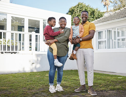 we-are-thankful-our-family-shot-couple-standing-front-house-with-their-two-children.jpg