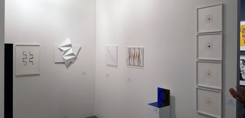 View of the stand of the studio Éditions Fanal at Art Basel 2018, Basel, white reliefs by Fabrice Ainaut and constructed works hung on a partition wall, 2018