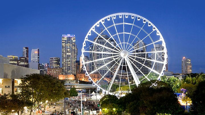 With more than 65,000 LED lights, the Wheel of Brisbane stands illuminated against the city skyline.
