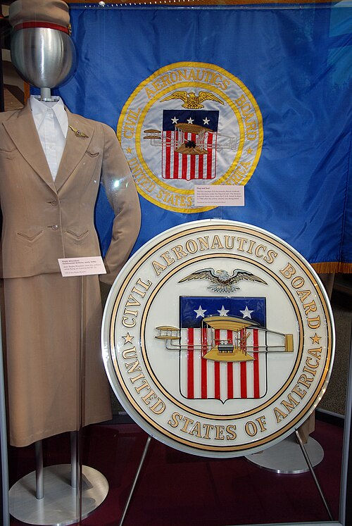 The CAB flag and seal alongside a flight attendant uniform at the National Air and Space Museum.