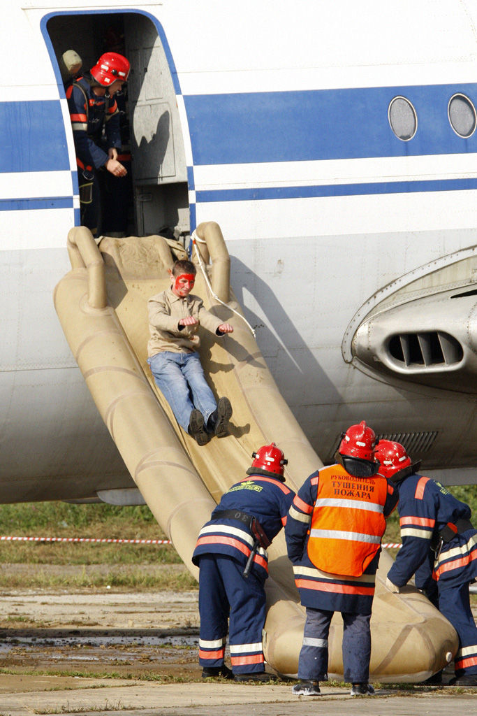 Able-bodied passengers are often called upon to assist with emergency aircraft evacuation slides.