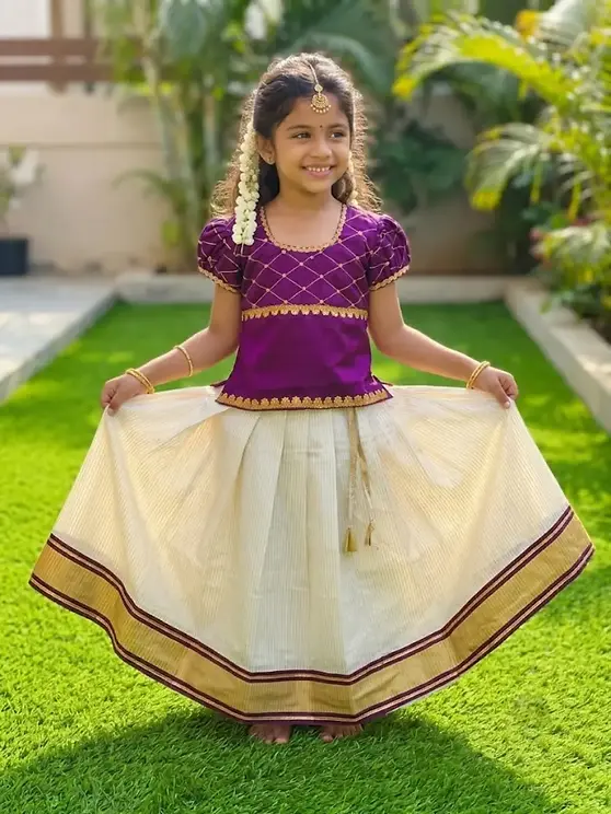 kerala cotton dress ' Onam Collection Kerala cotton A-line dress with a yoke neatly embroidered with kalamkari face motif. Mirror added for a gentle sparkle. It has piping around the neck and yoke for a