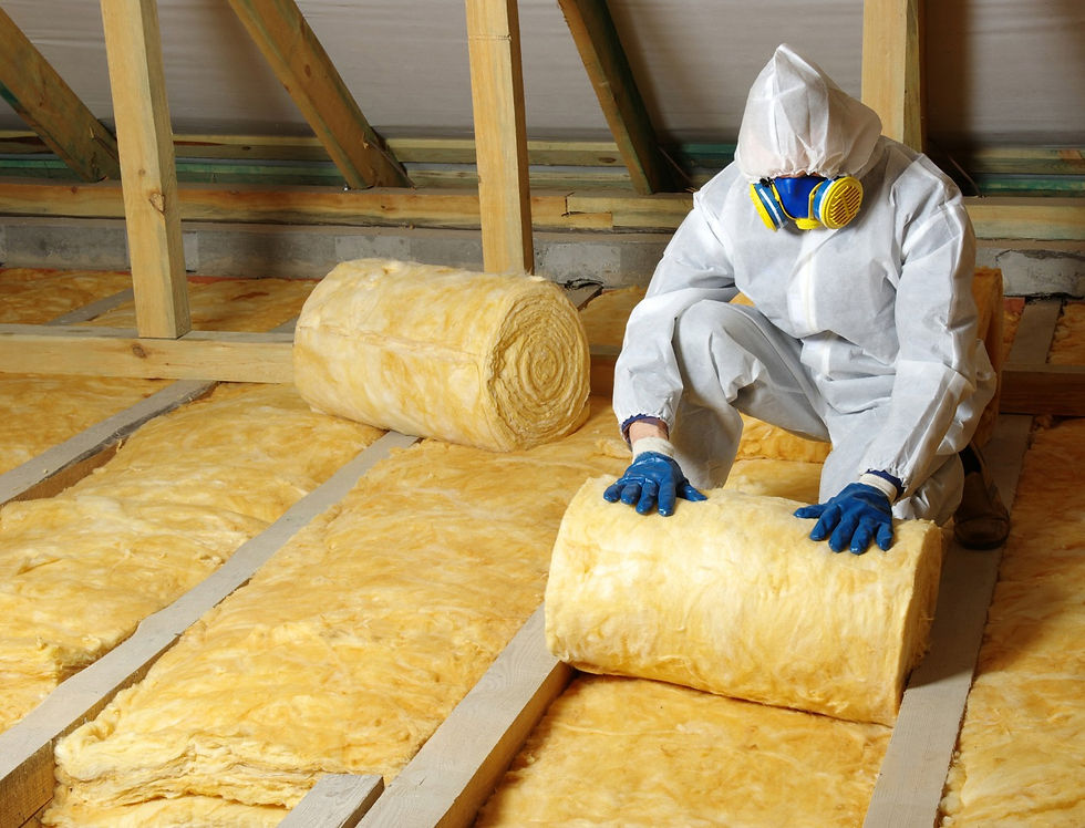 Installation of fiberglass batt insulation rolled out across the attic.