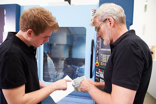male-apprentice-working-with-engineer-on