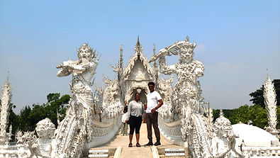 Travelers visiting the White Temple in Chiang Rai during a private day trip from Chiang Mai.