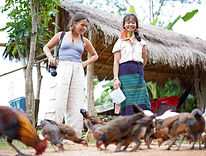 Travelers spending time with local villagers during an authentic cultural experience in Chiang Mai.