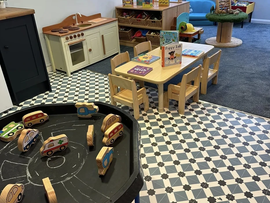 Tables with wooden cars and books for toddlers to play with