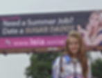 Lana Del Rey standing in front of a Sugar Daddy billboard