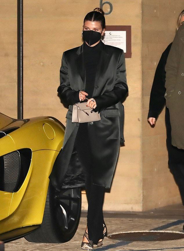 Sofie Richie with a black Satin silk coat