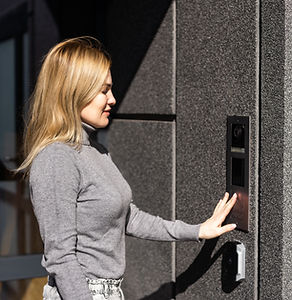 woman using intercom at building entrance..jpg